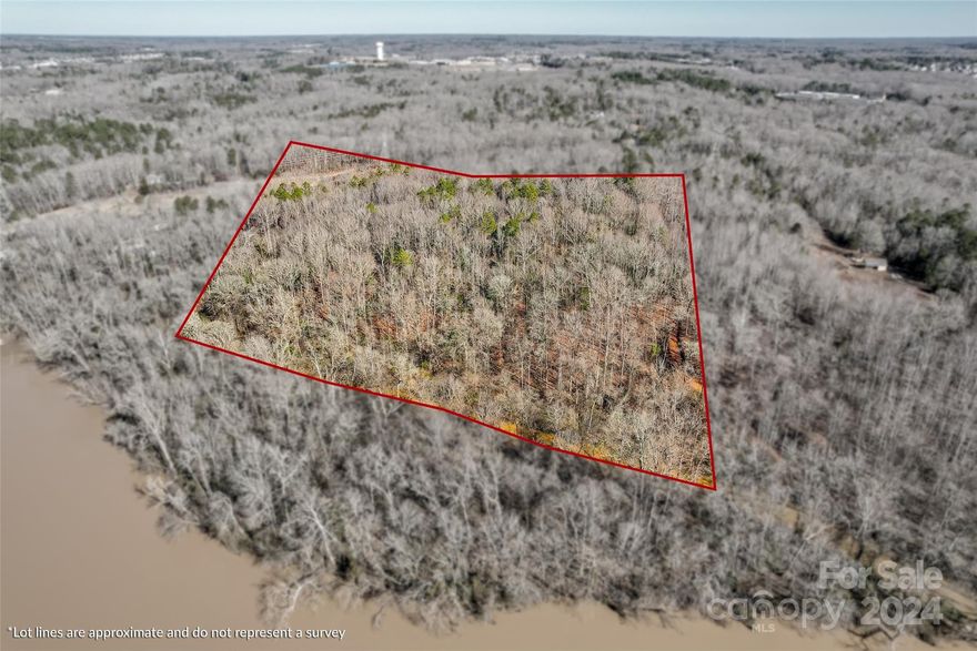 25 Acres + or - Beautiful parcel of land with old-growth mature hardwoods that touches the area where Sugarcreek and the Catawba River join. Multiple building sites would include views of the Catawba River. This beautiful hard-to-find forest combines White Oak, Red Oak, Ash, Poplar, Beach, and Evergreen Holly. This large parcel of land gives the owner a choice of building sites with lots of room left over for recreational purposes, riding all-terrain vehicles or horses, and hunting Whitetail deer on your very own estate, 38 min to uptown Charlotte,42 min to the Charlotte airport Powerline right of way crosses a portion of the property, small area of the floodplain near SugarcreekThis property has been given an address for 911 purposes. A new address would be needed for any building permit.