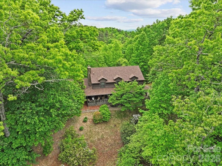 Tucked away on a private, wooded 2.13-acre lot, this charming 1985 cabin-style home offers peaceful living surrounded by nature. Inside, you’ll find warm wood tones and a welcoming layout with a cozy wood-burning fireplace — the perfect spot to gather on cool evenings. Enjoy morning coffee on the porch, afternoons exploring your own wooded acreage, and quiet nights under the stars. The home has been updated with new shingles, soft washed and re-stained siding, new toilets throughout, new back decking, new laminate flooring upstairs, and a crawlspace encapsulation and dehumidifier. This well loved home allows for peace and quiet while still offering the convenience of only 5 minutes to downtown Old Fort, 15 minutes to Marion, and 30 minutes to Asheville.