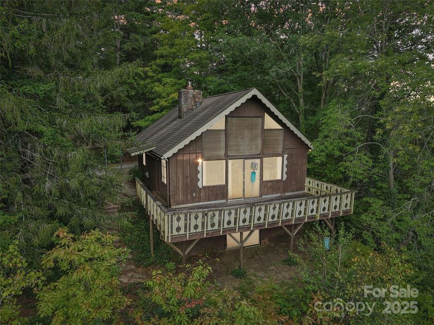 Perched on an unrestricted acre with wide west-facing views of the Blue Ridge Mountains, this mountain retreat offers both comfort and potential. Thoughtfully maintained over the years, it is ready for its next chapter—whether refreshed with modern updates or reimagined with a new vision. With its rare blend of privacy, year-round mountain views, and a prime location just minutes from Pisgah National Forest and the Ecusta Trail, this property is a true mountain haven.