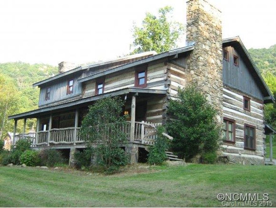 Want the real thing? Authentic Hand-Hewn Log Cabin;Logs are from the 1800's era.This cabin has history!Original Cabin built by homestead owner in the late 1800's.Additional logs were added in 2005 by new owner.Open floor plan offers Log beams,lots of space,stone fireplaces,hardwood floors, tile kitchen, gorgeous solid stone walk in shower on first level,covered front and back porches,Mountain Views,pond,bordering Bold Spring Creek on 2.89 acres