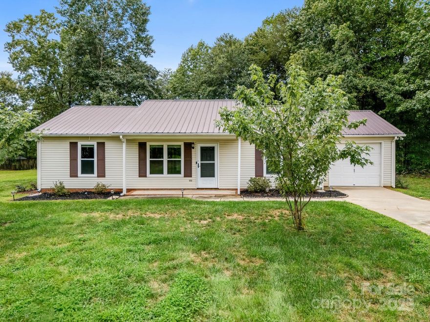 Discover your private retreat on nearly one acre with NO HOA! This beautifully maintained, MOVE-IN-READY 3BR/2BA ranch in desirable Pumpkin Center/N. Lincoln Schools offers quiet country living just minutes from shopping, dining, and Lake Norman. Perfectly positioned on a low-traffic, no-outlet road, this home boasts a vaulted ceiling in the main living area and a .94-acre lot with plenty of space to add your dream shop, additional building, or pool. Recent updates provide peace of mind: metal roof, water heater, tile flooring main areas & baths (wood-look finish), granite kitchen counters, stainless steel appliances, UV-tinted windows 40-yr warranty, gutters leaf protection, Ring camera, New AC Jan-25, cordless blinds, ceiling fans. Relax and entertain outdoors around oversized fire pit, take in sunset views from backyard, utilize the 12x12 storage building for hobbies or tools. A rare opportunity to enjoy a peaceful, country setting without sacrificing convenience. Make this yours!