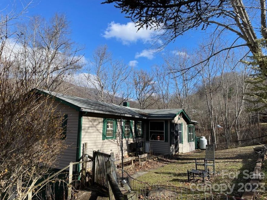 Classic 1960's Cottage near Little Rock Creek. 2bedroom/ 1bath with large kitchen, living room and laundry area.  Unfinished basement with entry on both sides. Easy basement access on one side with road right to the door. Small enclosed mud room at front door, and large side deck with views of the mountains. Pet freely with a fenced in front yard.  Rock patio for BBQ/grill or outside sitting. House needs updating!