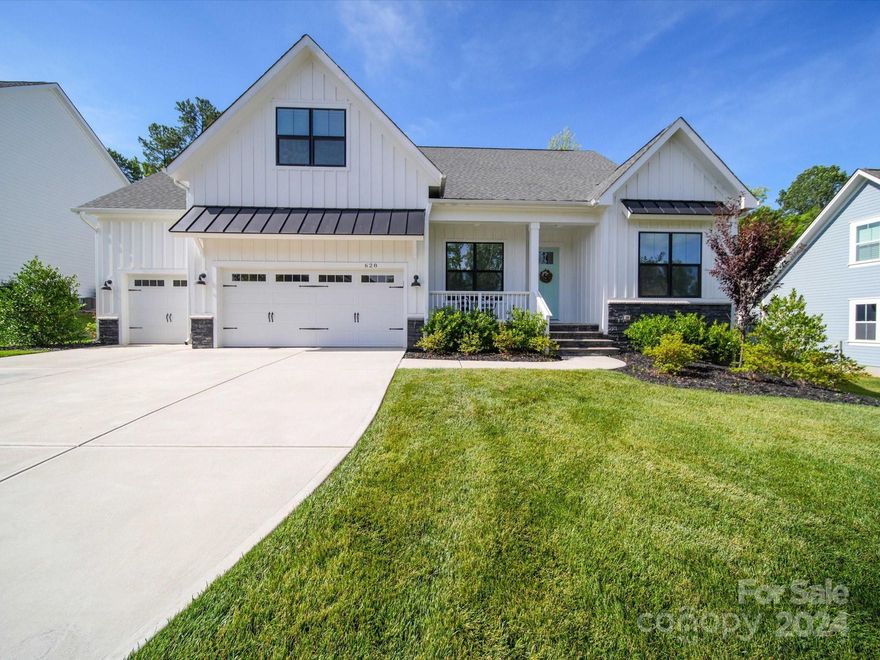Rare find in the sought after community of Nims Village! This custom home with upgraded finishes and craftsman trim has a true modern farmhouse feel. A main level primary suite features walk-in shower and swoonworthy closet cabinetry. The chef's kitchen with large island was expanded to include a coffee/wine bar. The living room with shiplap surround gas fireplace and built-ins is the perfect area for relaxing or step onto the covered rear porch and enjoy your outdoor fireplace. Judges panel in the dining room adds a touch of sophistication for entertaining, and an additional downstairs bedroom with en-suite is perfect for guests. The office with french doors completes this very livable main floor so head upstairs to check out two more bedrooms and a full bath. Too many upgrades to list here so please see attachments and the virtual tours. A Harris Teeter shopping center is planned adjacent to the neighborhood and could soon provide convenient access to even more retail/restaurants.