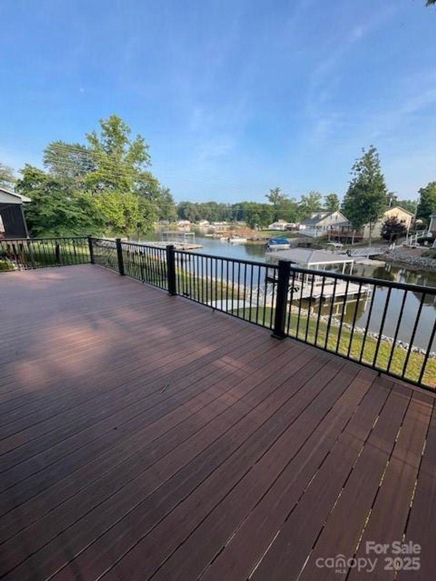 Lake life living on beautiful Abbotts Creek on High Rock Lake in a newly renovated home! You will love the gently sloping walk to your private, newly constructed, covered U-shaped aluminum boat dock! The views from the outdoor deck and covered patio area are simply amazing! This renovated WATERFRONT lake home also has newer LVP floors throughout the home and walk-out basement! All NEW shingled roof, windows, siding, floors, decking, garage doors and so much more! 2 car attached garage with a separate 2 car detached garage. Split unit in the walk-out basement for hosting/entertaining friends and family! Abbots Creek near High Rock Campground w/ approx. 6.0ft depth at full pond.  Pre-approved buyers welcome! Come make this lake front home your dream home and schedule your showing today!