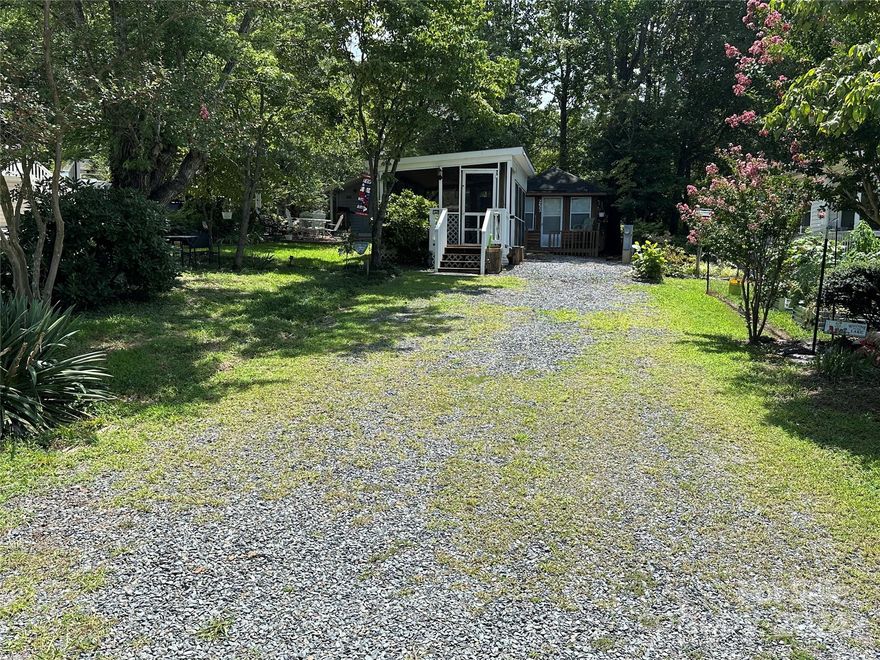 Welcome to lake life living at Badin Shores Resort! This flat, level, and spacious lot offers the perfect canvas for your dream getaway. Enjoy the outdoors in your screen room, tailored for your camper, or seize the opportunity to acquire the existing camper on-site. Two storage buildings provide ample space for your water toys and beach chairs, ensuring everything is neatly organized. Nestled under the comforting shade, this convenient location is just a stone's throw away from the swimming pool, basketball courts, picnic pavilion, putt-putt, fitness center, and more.  Venture out in the resort an enjoy the nearby waterfront boardwalk, boat ramp, fishing pier, stocked fishing pond, community clubhouse, sandy beach, and the inviting lake swim area—all just moments away. Seize this opportunity to create lasting memories in a prime location that combines convenience, comfort, and the resort lifestyle offered at Badin Shores Resort. Partial owner financing is available.