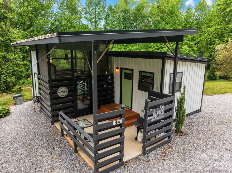 Welcome to "Mac" & "Mini" two adorable tiny homes set on a tree studded acre plus of land just 2 miles from Marion's charming Main Street.  They are currently active short term rentals offered fully furnished & completely turnkey. Mac's 296 square feet of living space includes a walk in shower, full kitchen, patio, screened in "spa" w/ a soaking tub, a detached covered patio w/ super comfy hanging chairs & a gas fire pit.  Mini is a tiny but mighty 165 square feet of living space complete w/ kitchenette, shower w/ mini tub, open deck overlooking the spacious property, covered fire pit area & picnic table.  Please note: the living rooms are used as bedroom studio setups, so the properties are listed as having a bedroom in each unit even though they are not a separate bedroom area.  Both structures are reflected on the tax card, however there are no permits for the structures to our knowledge.  Both have been popular vacation rentals since 2019- current owner has had them since 2021.