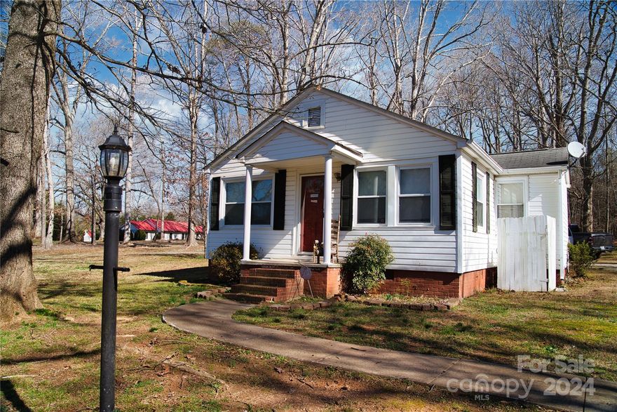 This charming residence is nestled in the Cherryville area, featuring approximately 1.30 acres of serene surroundings and conveniently powered by Duke Energy. The property includes a fenced-in yard housing a versatile workshop/building, perfect for various endeavors. Recently enhanced with a brand-new backdoor, the home exudes comfort and functionality. Inside, the elegant living room and bedroom are adorned with timeless hardwood flooring, complemented by abundant natural sunlight, which adds a touch of warmth and character to the interior ambiance. One room was used as a bedroom but does not have a closet.