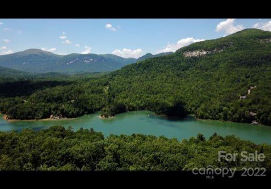 Stunning lot with potential magnificent views of Lake Lure, Rumbling Bald and Chimney Rock once some trees have been removed.  Build your dream home on Millionaires Row!  A topographical survey has already been done on this lot with all markers still in place.  Short term rentals are allowed in this subdivision.  Rumbling Bald boasts two world class golf courses, indoor and outdoor swimming pools, a lazy river, mini golf, tennis courts, fitness center, restaurant and its own private beach.  This lot is one of the few that  are readily buildable with a gentle slope closer to the road.