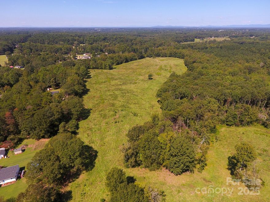 Discover a rare opportunity to own a breathtaking +/- 44-acre property in the Patterson Springs community of Shelby, NC. From the property’s high points, enjoy sweeping views of the majestic South Mountains.

This versatile tract features approximately +/- 26 acres of productive, tillable farmland with the remainder in mature timber—perfect for recreation, farming, or future development. A creek runs along the northern boundary line, adding natural beauty and an additional water feature to the property. It’s an exceptional setting to create a private family estate or compound where lasting memories can be made.

Conveniently located, the property is just +/- 4 miles from Business 74 in central Shelby, +/- 8 miles to I-85 (Blacksburg exit), +/- 12.5 miles from Two Kings Casino in Kings Mountain, and only +/- 44 miles to Charlotte Douglas International Airport.

Currently utilized for farming, the property is truly turnkey. According to Cleveland County, a 6-inch waterline is located along Ellis Road, enhancing its potential for future use.

An investment in location, lifestyle, and long-term value—this tract has it all.
