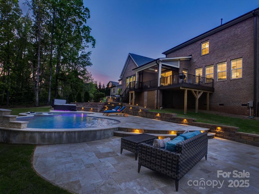Nestled at the end of a quiet cul-de-sac in the sought-after Eppington South community, this stunning, magazine-worthy home offers the perfect blend of luxury, comfort, and Southern charm. Inside, discover custom designer touches throughout—an elegant dining room, private office, and a sun-drenched living room that opens to a chef-inspired kitchen with quartz countertops, stainless steel appliances, and room to gather. The main-level owner’s suite feels like a luxe retreat with a spa-like bath and custom dual closets. Upstairs, find four spacious bedrooms, two full baths, and a walk-in attic for storage or future expansion. Outside features your own private paradise: a screened-in porch, travertine patio, shimmering pool, and built-in outdoor kitchen—ideal for BBQs and summer nights under the stars. With a 3-car garage, top-rated Fort Mill schools, and proximity to shopping, dining, Lake Wylie, and more, this home truly has it all.