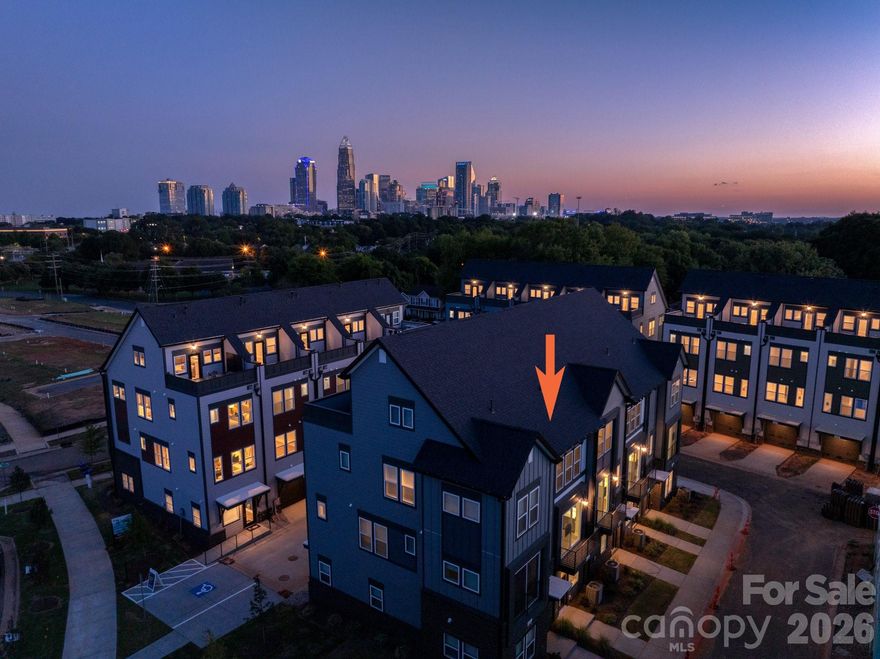 City skyline view! This is a versatile 4-story townhome, featuring a top floor bonus bedroom room & rooftop terrace, plus first floor Flex room w/ powder! The open layout of the second floor makes gatherings a breeze. Or meet friends at Camp North End, located just across the street. The Kitchen features 42" grey cabinets with quartz counters, backsplash, under-cabinet lights, trash pullout, pantry cabinet, and GE stainless steel appliances with a gas range, plus large undermount stainless sink. Full baths include grey cabinets, quartz counters, and tiled floors, with a large tiled shower in the Premier Bath with semi-frameless glass. Low maintenance LVP floors are throughout the first and second floors, plus third floor hallway, with tile in full baths and laundry closet. Oak treads are on the stairs. 52" ceiling fans are in the flex, bonus bedroom, living and Premier bedroom. 9' ceilings throughout; 1-car garage plus on-street parking is available. Enjoy very close proximity to Uptown Charlotte.