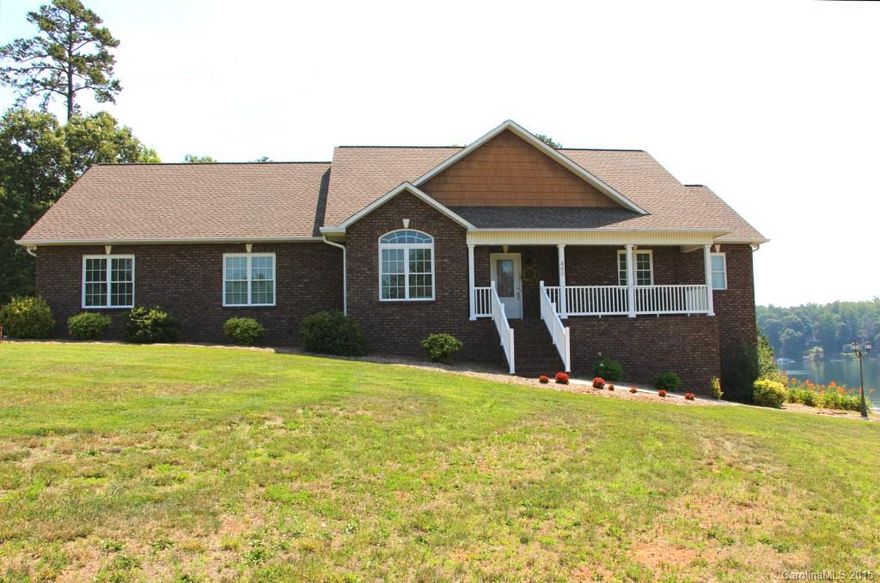 3 BR, 3 BA ranch w/bsmt & great views of Lake Hickory. Located in a lakefront community this home has a deeded shared dock. Custom built home w/ covered front porch, screened-in porch & back deck w/handicap access ramp. Open floor plan w/living room featuring a floor to ceiling stone, gas log FP, hdwd floors, vaulted ceiling & recessed lighting. The kitchen overlooks the living area & has breakfast bar, granite, SS appliances, pantry & large dining area. Large MBR w/WIC, MBA w/double sinks.