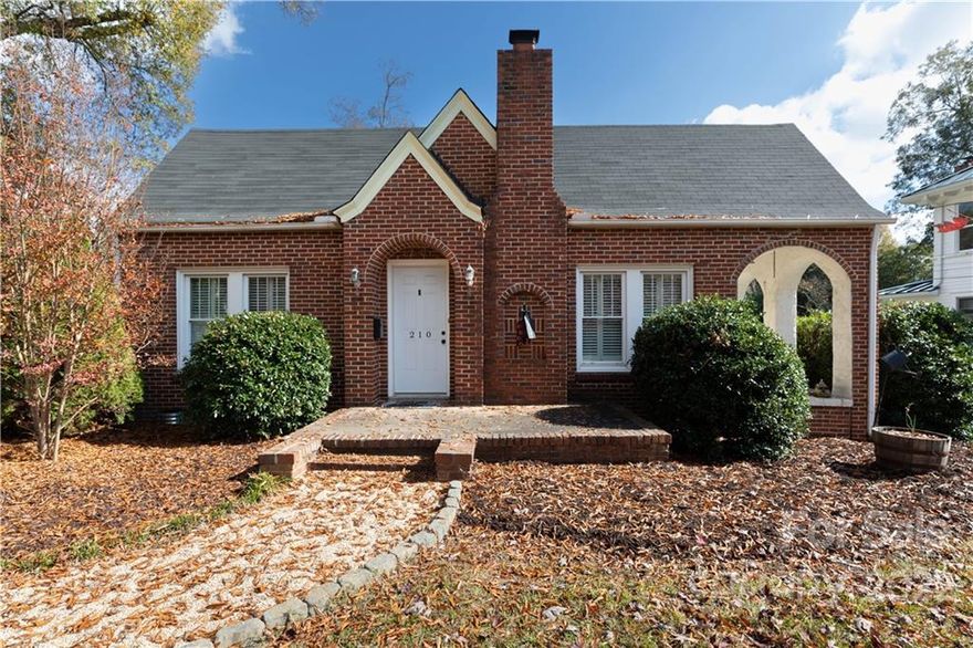 A sweet southern charmer that brings you the cherished treasures of times past with updated features!  The enchanting beauty of arches with the front door entrance and that side porch will mark your heart swoon.  Inside it's spacious with almost 1700 sq ft with glistening hardwoods in much of the living area and an updated bath with a tiled walk-in shower.   The living room opens to the dining room accommodating great space to dine and relax for you and your guests.  With just under a 3/4 acre lot located in the Historic District, you'll love the outdoor space with privacy, the autumn colors on the trees, and even a detached garage with a porch!  Let us welcome you Home to 210 Kings Mountain Street!