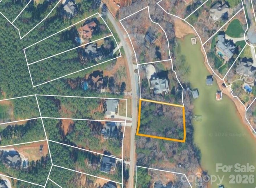 Positioned along 155 feet of Lake Norman shoreline, this wooded ¾-acre waterfront homesite presents a rare opportunity to create a custom residence in a private, natural setting. As the last remaining waterfront lot within this no-HOA community, it offers a truly limited opportunity. With access via a publicly maintained road, the property provides both flexibility and ease. An existing older dock is already in place, enhancing the lakefront lifestyle. Of the two adjoining lots, this offering represents the left parcel.