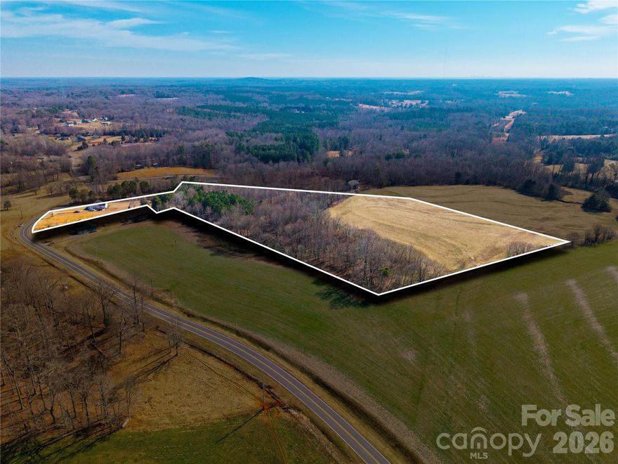 Discover the possibilities with this unique 10+ acre parcel offering space, privacy, and flexibility for your future plans. The front portion of the property features a flat street-side entrance, currently covered in tall grass. A narrow strip of land leads you to the expansive rear section, where the majority of the acreage opens into a wide, cleared field — an ideal setting for your future build.The back portion is completely cleared of vegetation and bordered by a natural tree line, providing both openness and a sense of privacy. A small pond is located on the property, adding charm and potential for a peaceful homesite setting. The overall topography is mostly flat with a very gradual upward slope, making the land highly usable and well-suited for construction.A few neighboring homes are nearby, while the size of the property still allows for a private, peaceful setting. No perk test on file and no survey available.