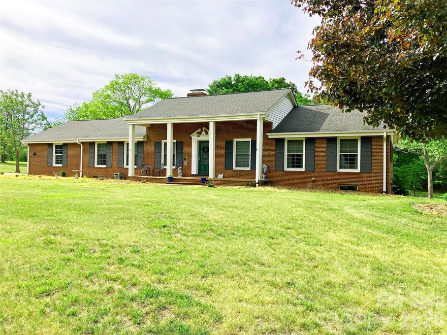 Recently remodeled brick home on a desirable corner lot with mature trees, large yard and a 2-car attached garage. Close to town, but not in-town. The neighborhood primarily consists of similar size, well-maintained homes, also with large yards.
The large primary bedroom has its own attached bathroom with a custom tile shower, separate tub and a walk-in closet. Full-glass enclosed back porch is an inviting and unique space; a relaxing place to spend time year-round. Attached deck with access off the porch and dining area makes for easy alfresco dining or entertaining.
 Library / reading area with large built-in bookshelves. Fully updated kitchen with double ovens and a gas cook-top.
 Kitchen and laundry appliances are almost new and are included. Large (2091 square feet!) of walk-out basement space (not included in the heated square footage) that was set up as a separate apartment at one time and could be set up that way again if desired. Workshop and plenty of basement storage in the home. Detached garage with carport that could be used as an additional workshop and/or additional garage/shop space.

 The sale will include a portion of the adjacent lot that contains the detached garage and about 30' of additional yard alongside the the length of the driveway. Total acreage will be about 1.48ac combined. (see pictures for outline of the new lot).