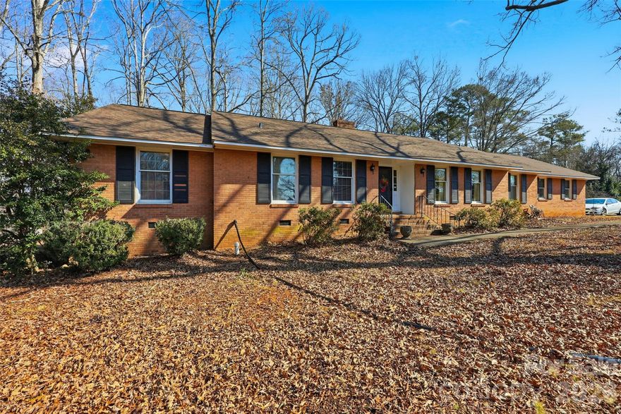 Exceptional opportunity to transform a solid all-brick ranch situated on a stunning, nearly one-acre (.95) developed lot in a prime Rock Hill location. Just minutes from downtown Rock Hill and I-77, this spacious home offers 3 bedrooms, 2 full bathrooms, and a half bath, with a sprawling floor plan, generous room sizes, and solid
brick construction—an ideal investment for a high-end renovation or strategic value-add investment. The beautifully developed lot provides privacy, mature surroundings, and ample space for elevated outdoor living. Being sold as-is and priced to reflect needed repairs, this property presents a rare opportunity for investors, renovators, or buyers seeking to create a luxury residence while building equity in a highly desirable location.  Roof was replaced 2024.