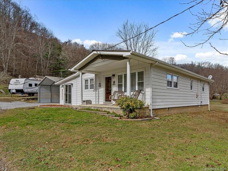 Cozy 3 bedroom 2 bath home minutes to Downtown Waynesville and within walking distance to Allens Creek Park. This home boasts beautiful oak cabinets with laminate wood flooring throughout. Spend your evenings relaxing by the wood burning stove or the beautiful rock fireplace. You will find plenty of storage in the  16'X24' storage building located across the street. Please note, ceiling height in corner bathroom/laundry room is below 7 ft (total of 75 sf). PIN Numbers 8604-61-5155 and 8604-61-5044 convey for a total of 0.39 acres.