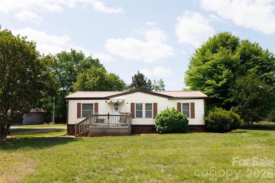 Welcome to this cozy doublewide nestled on 0.66 acres in North Statesville, just minutes from the charm and scenic trails of Love Valley! Built in 1989, this 3-bedroom, 2-bath home offers a functional split-bedroom floor plan and plenty of potential for the right buyer willing to add a little TLC.
Major updates have already been taken care of, including upgraded windows, a durable metal roof, low-maintenance vinyl siding, and a brick foundation—giving you a solid starting point to make this home your own.
Step outside and you’ll find what truly sets this property apart—tons of outdoor space perfect for relaxing or entertaining. Enjoy gatherings on the spacious back deck, take advantage of the covered parking areas, and make use of multiple outdoor storage buildings for all your tools, hobbies, or equipment.
Whether you're a first-time homebuyer looking to build equity or someone ready to downsize and enjoy a quieter setting, this property offers great value and endless possibilities in a peaceful, country-inspired location.