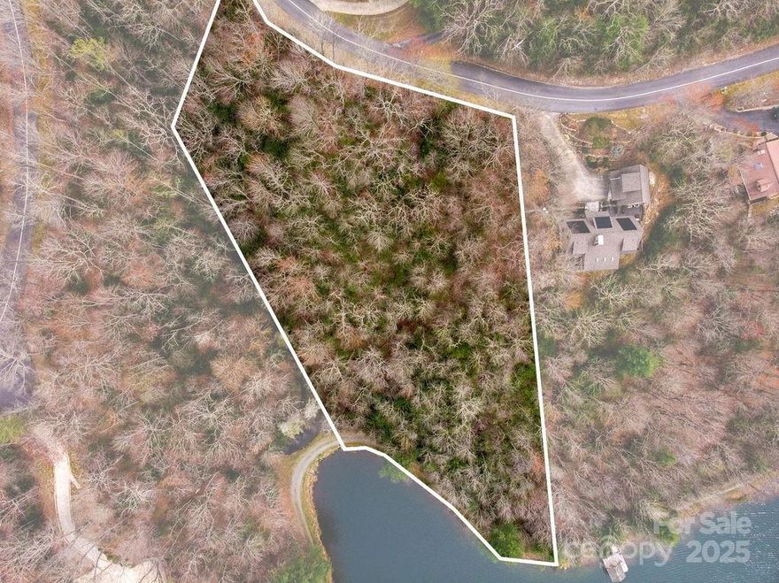 There just aren't lots like this left!!! Build your dream home on this huge 2.27 acre lakefront lot located at the center of Lake Ticoa in Connestee Falls. Watch bald eagles catch fish on the clearest lake in Connestee Falls. Long range mountain views possible from the private street. Connestee Falls is a nature lovers paradise, with 4 private lakes, over 20 miles of the best hiking trails around, full 18 hole golf course, clubhouse with 2 restaurants, social clubs, tennis and pickleball courts and more. Don't miss your chance, this one is rare!!