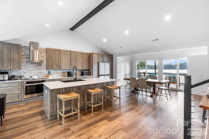 ~Located on the SUNSET side of Lake Wylie in Charlotte, this fully renovated lakefront retreat will take your breath away! This exquisite three-bedroom, three-bath custom home feels like new construction, showcasing a complete transformation with brand-new kitchen, bathrooms, flooring, electrical, plumbing, roof, and exterior—every detail thoughtfully updated. Inside, you’ll find luxury vinyl plank flooring, stainless steel appliances, quartz countertops, and custom cabinetry, all bathed in abundant natural light from the home’s expansive windows. Enjoy spectacular sunset views over Lake Wylie from nearly every room. Step outside to your own private pier and charming little beach area, perfect for swimming, fishing, or launching a kayak. Spacious decks make entertaining a breeze, and there’s plenty of parking for guests. Just minutes from the exciting up-and-coming River District, downtown Belmont, and acclaimed dining hotspots like Papa Doc’s and Drift, this home offers the perfect blend of tranquility and convenience. Whether you’re seeking a primary residence or a weekend getaway, this stunning property delivers a one-of-a-kind lakeside lifestyle.