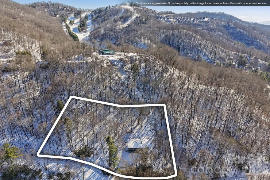 Welcome home to 210 Spring Valley in the sought-after, 5,300-acre gated community of Wolf Laurel, surrounded by the Pisgah National Forest and protected lands. Set on a double lot with golf course views, this home offers the perfect blend of privacy and easy access, just minutes from the front gate, the Village Club, and Hatley Pointe Ski Area.  Freshly painted and move-in ready, the layout provides plenty of room to spread out. The primary bedroom is on the main level with an ensuite full bathroom. Upstairs, you’ll find a bonus room/office and half bath, along with the home’s main living spaces: living room, dining area, and kitchen. The lower level includes another bedroom, a bonus sleeping room, two full bathrooms, and a mudroom and laundry room just off the double covered decks, plus two generous storage closets and direct access to the one-car garage. With its close proximity to the ski slopes and flexible sleeping space, this home is ideal for full-time living, a mountain getaway, or a vacation rental. Natural light fills the living space, and the covered decks invite morning sunrise coffee, evening sunset gatherings, and quiet time in the crisp mountain air. Wolf Laurel is a lifestyle all its own, with 24-hour security and an impressive list of optional amenities. The Village Club membership conveys with the sale (plus transfer fee) and includes pickleball, tennis, a sports court, playgrounds, a stocked trout pond and streams, and a community pavilion and event center. Optional membership to the Wolf Laurel Country Club offers a 24-hour fitness center, a 5-star golf course, and social amenities. Outdoor lovers will appreciate the 50 miles of internal trails with multiple access points to the Appalachian Trail, plus endless adventure right outside your door—hiking, biking, skiing, and exploring the Pisgah National Forest.  When it’s time to venture out, you are about 45–50 minutes to Asheville or Johnson City, TN (both with regional airports). Numerous charming mountain towns and local favorites for everyday supply needs are just 15–20 minutes away in every direction.  Easy, welcoming, and set up for mountain living, 210 Spring Valley is ready for your next chapter.