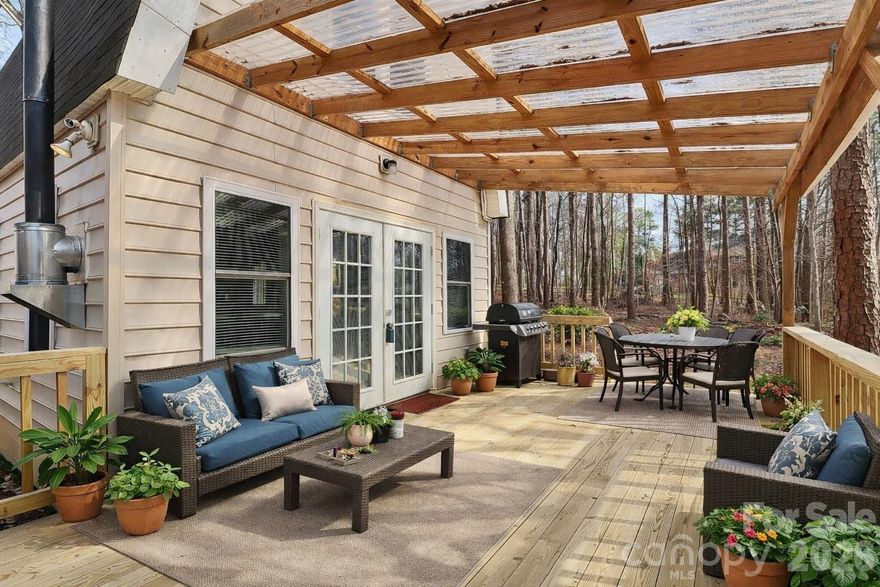 AGENTS - PLEASE VIEW AGENT REMARKS IN THE MLS. “Acreage. Location. Opportunity.” Escape to your own private woodland retreat on 2 secluded acres, where nature surrounds you and convenience is just minutes away. Tucked among mature trees yet close to I-485, Mint Hill center city, and under 15 miles to Uptown Charlotte, this rare property offers serenity without sacrificing location. The open-concept main level features a spacious living / dining area that flows seamlessly into the kitchen. The kitchen includes a smooth- top range, microwave, dishwasher, open pantry area, and a built-in feature perfect for a desk or stylish coffee bar. LVP flooring runs throughout the main level, and an abundance of windows fills the home with natural light. A wood-burning stove creates the perfect cozy cabin ambiance on cool Carolina evenings. French doors lead to a covered deck — the perfect place for morning coffee or quiet evenings immersed in nature. Also on the main level, the half bath includes washer & dryer hookups for added convenience. (Dryer conveys) Upstairs offers two bedrooms with built-in storage in the hallway along with a skylight. One bedroom features access to a Jack-and-Jill bath shared with the hallway for added convenience. The outdoor space offers a peaceful, wooded backdrop perfect for enjoying nature, hosting around a firepit, or relaxing on the covered deck. The setting provides a sense of retreat while still being part of an established area with neighboring homes nearby, creating a comfortable balance of seclusion and connection. With NO HOA and a setting that feels worlds away from the city, this property delivers privacy, charm, and a true retreat-like lifestyle. A rare opportunity to own acreage in such a prime location — your woodland escape awaits. Offers may be entered ONLINE through Monday, March 23, 2026 at 2:00 pm.
AT SELLER'S DISCRETION, AN OFFER MAY BE ACCEPTED AT ANY TIME.