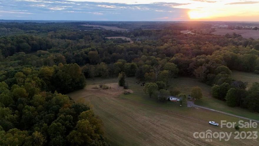 Land that features two home sites & 560ft River frontage. A 3 bed 2 bath Singlewide on 3 acres with two other additional parcels for a total of 22.76 acres.  Appliances and Storage shed conveys with home. Per sellers the Singlewide has a Metal roof approximately 5 years old, Septic was recently checked and pumped, Has a new Well pump and filter.  Home is in need of renovation but has great bones, as far as sellers are aware there are no major issues other than flooring, paint, and an extremely good cleaning due to animals. Additional 4.6 acre lot previously had a doublewide so there is a power stubbed up for connection and a separate septic system. Sellers are unsure of water source for that lot.   Approximately 16+ acres are clear with 2 parcels connecting to the South Yadkin River, the bottoms is a site to see.  There are 2 Deeded easements for access to these properties from Stroud Rd. Would be a great homestead sitting off the beaten path for privacy but less than 5 miles to I-40.