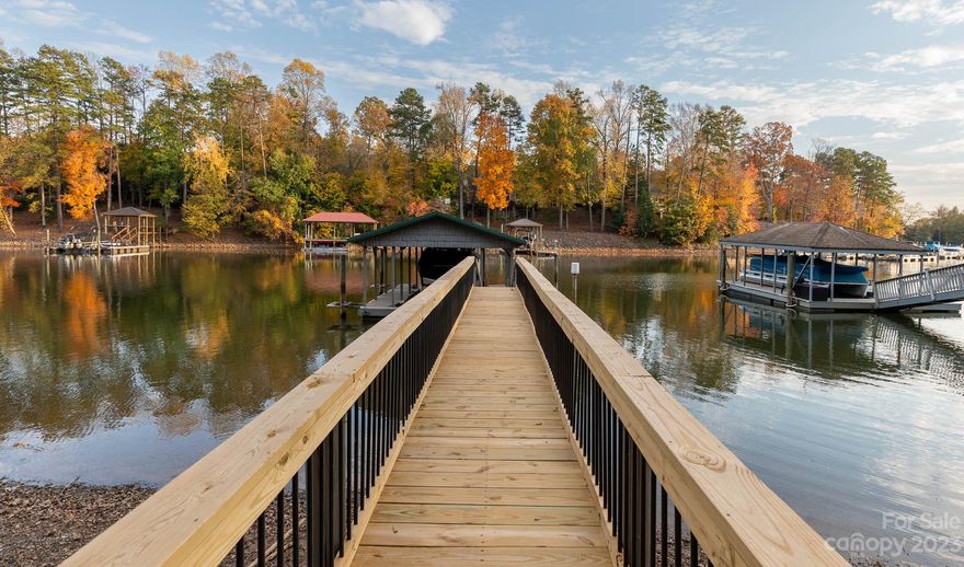 This house on Lake Wylie is truly a remarkable property. The main level boasts stunning features, including a great room with vaulted ceilings, stone fireplace & built-ins. The open floor plan seamlessly connects the main level kitchen, complete with work island, granite countertops, walk-in pantry & breakfast area. Additionally, the main level offers a sunroom with picturesque views of the pool & lake, a formal dining room & a luxurious primary suite. Upstairs presents a versatile bonus room that could serve as a fourth bedroom, although the septic system is designed for 3 bedrooms. Meanwhile, the basement is a functional space with a second kitchen, 2 bedrooms, 2 full baths, a family room with a fireplace & ample storage space. The outdoor amenities are equally impressive, featuring an inground saltwater pool with a waterfall feature, a fenced yard, a pier with a gazebo, a floating dock, a boat lift & a built-in gas grill. Conveniently located near downtown, shopping & dining.