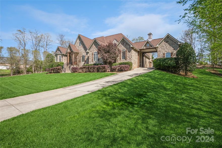 This stunning 4 bedroom, 1.5 story home is located in Lake Wylie. It sits on 2.53 acres with 2 entrances, custom finishes throughout and no HOA! All bedrooms are on the main floor with a bonus upstairs. This home features a custom gunite pool and spa that flows down an 8 foot waterfall and is surrounded by a perfectly landscaped fenced yard. Some unique features to this home include a sports field with a paved cul-de sac, a two car garage, an additional one car garage and an RV sized garage with electrical and sewage outlets attached to the porte-cochére. Updates to this home include new garage doors with MyQ camera/smart system, outdoor gas fire pit, 2 new HVAC systems with 15 year warranty, refinished hardwoods and ceiling coffers and all new pool equipment with smart system controls. This home has wonderful utility, exceptional quality and amenities. You don't want to miss this one!