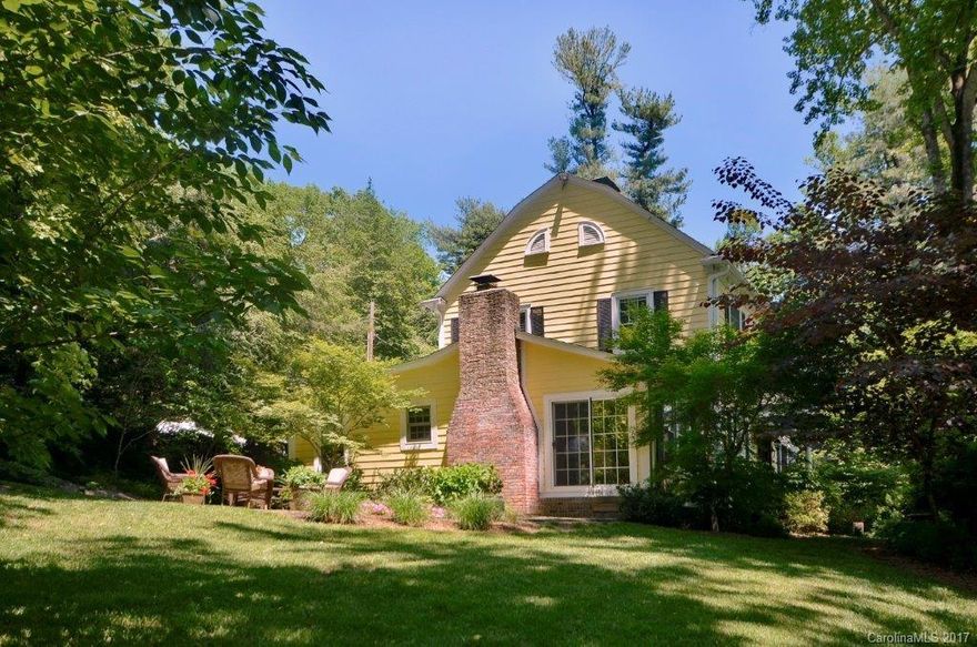 1940's charming! Idyllic setting offers privacy and atmosphere. All redone beautifully with thought and style. Crown molding, wainscoting, two fireplaces, wood floors, eat-in kitchen, library, family rm, foyer, mud room,powder room, laundry and garage on Main level. Upper level features master suite and two more bedrooms and bath. On sewer and natural gas. Charm, history, setting & location all in this offering in lower Laurel Park.