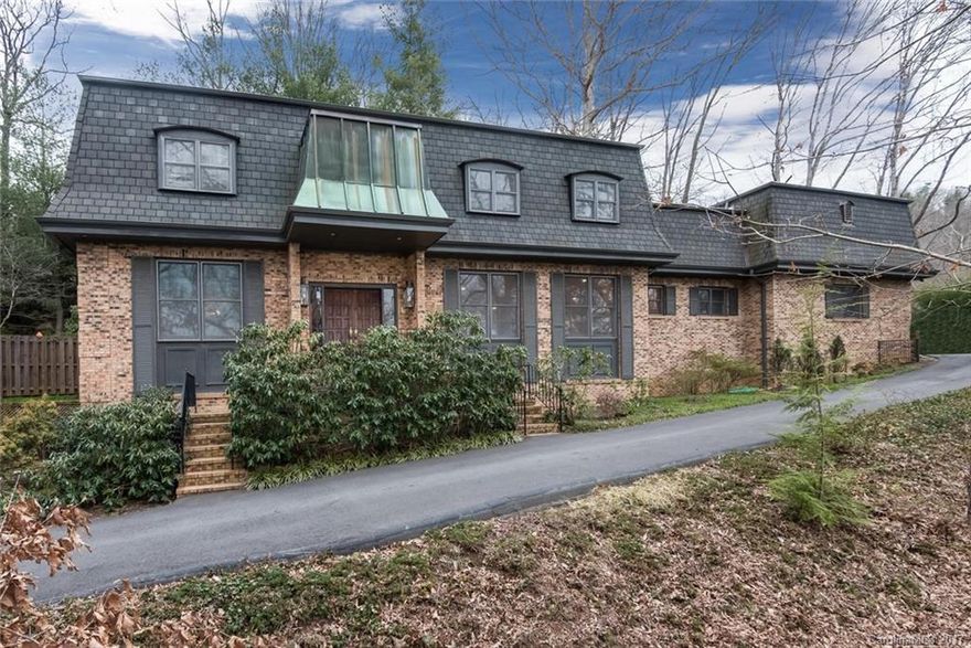 You'll feel as though you stepped right off the pages of a magazine in this stunning North Asheville French Provincial home. Entertain with ease as your family and friends gather in front of the French doors and fireplace just off the kitchen; then slip away for the evening as you ascend the wide spiral staircase with bespoke wool carpeting. Enjoy a dip in the solar heated pool or host guests in the in-law suite. Geothermal HVAC, patio gardens, and winter views complete this masterpiece.