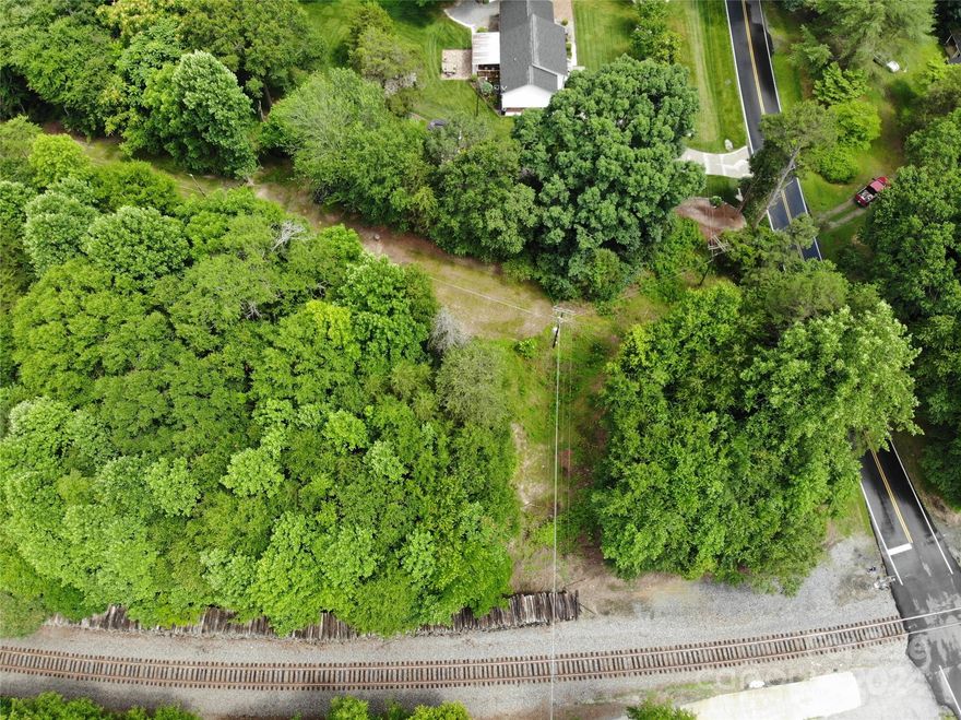 1.37-acre wooded lot available just across the railroad tracks off of 150 on Roseland Dr.  County water is available if tapped.  County says 6-7K to tap water.  Septic system will be needed.  No perc tests have been done.  The R-S zoning says stick-built homes allowed but no manufactured homes without an approved zoning variance from Lincoln County.  Power lines do cross the property about 1/3 in front.  Railroad tracks border property to the left, privacy fence on right side.  It's a nice high piece of land and could be yours.  Make your best offer today!