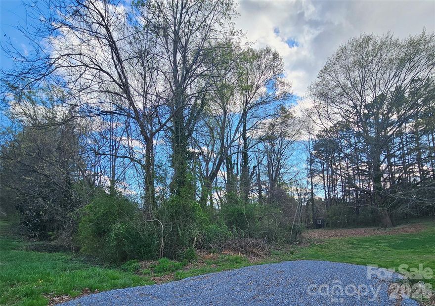 Don't miss the opportunity to build your dream home on this tranquil lot in an established neighborhood. Stream located on the front of the property for added ambiance. Convenient to Uptown Shelby which boasts shopping, boutiques and more.  Culvert in place and gravel driveway installed.  Survey on hand.  Trees along stream but partially cleared.