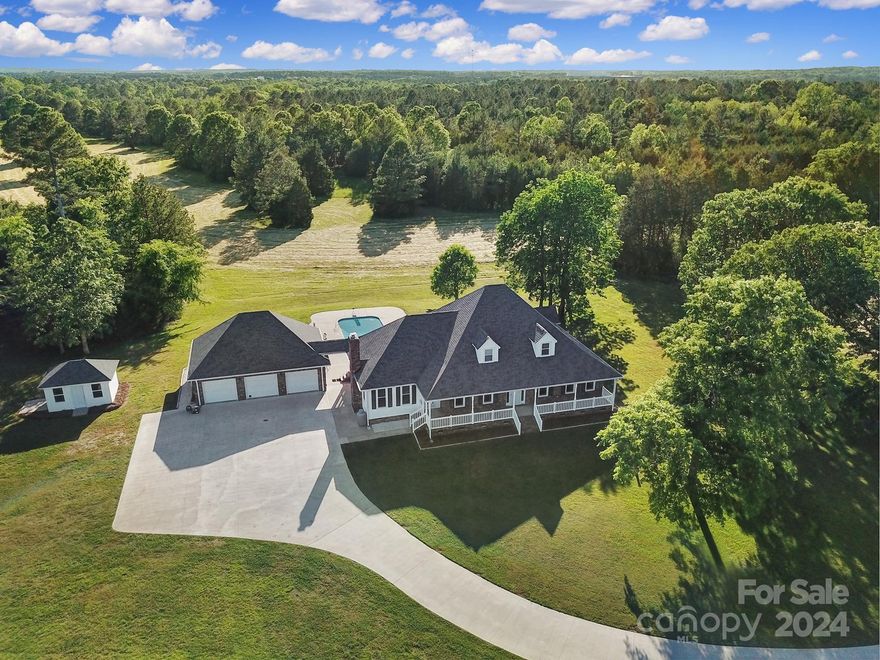 A 53 acre country estate w a blend of privacy, natural beauty & modern amenities. Features 15 acres of pasture, remaining 39 acres w a mix of hardwood, pine trees & walking trails. Located within a VERY short drive from I77 & ONLY 45 minutes from CLT airport. Main home is a stunning 3,324 square-foot home w 4 bdrms & 3 baths. Interior w elegant comfort offering a welcoming atmosphere for owners & guests. Oversized primary bdrm on the main, w en suite bath w walk in shower, soaking tub & double vanities & dbl WIC. Also one additional bdrm on main w 2 oversized bdrms & full bath upstairs. The open kitchen has a brkfst area w large eat at bar area w seating for up to seven. A formal dining area, office/study & laundry room are also on the main. There is also an expansive 3 car garage w a depth of 28 ft designed for full sized trucks. Parking for 6-7 vehicles (or more) is provided via a huge concrete area in front of the 3 car garage. There is a 2nd residence / guest house w 1232 sq ft.