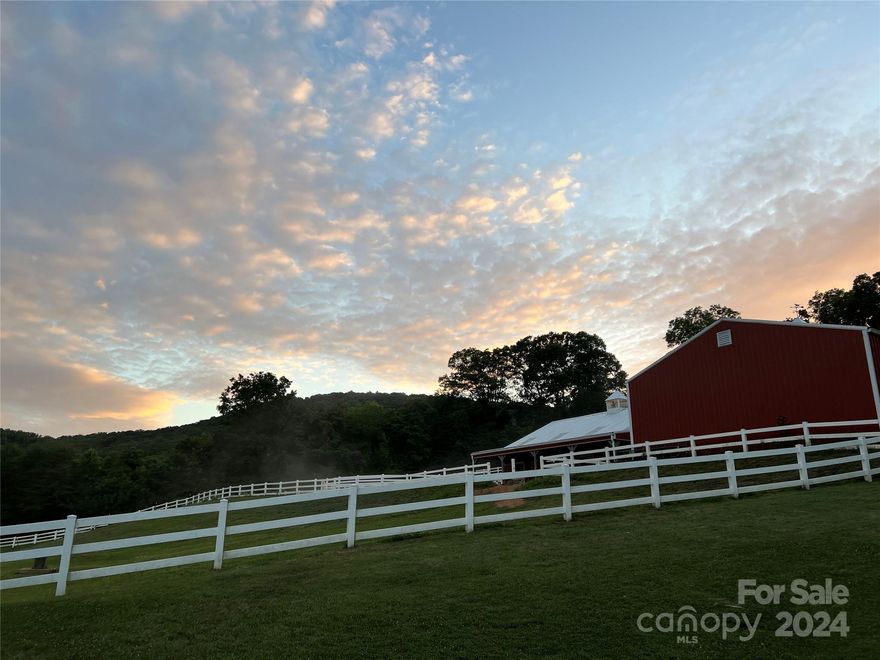 A captivating equestrian estate nestled 7 minutes from Asheville city limits. This extraordinary property spans  over 10.9 acres of picturesque views with upscale amenities. The property offers horse trail access to 18 miles of beautiful trails. The 3,486 sq.ft  home provides an open floor plan that provides a spacious layout.  For those passionate about horses, it offers a 4 stall horse barn that is thoughtfully designed, combining functionally with appeal. Each stall measures 12x12 with stall liners. The barn also includes a tack room with laundry, a bathroom, a feed room ample enough for supplies.  There is also an 36x40 equipment barn to store all of your equipment and trailers in. The property offers beautiful established and fenced pastures, with appointed water spigots, providing ample space for the horses to graze and roam freely. After riding during the day relax in swimming pool and hot tub that overlooks the most spectacular view you will ever experience.