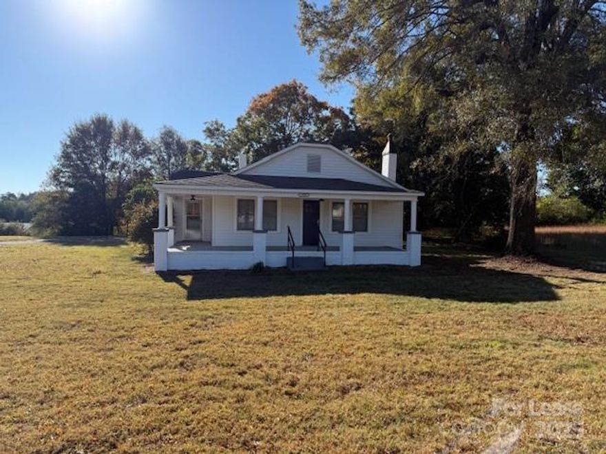 Discover country living with a convenient location! This charming 3-bedroom, 1-bathroom ranch home offers a classic design and is situated on a large, level lot with plenty of open space. Enjoy your morning coffee on the expansive wrap-around porch. Enjoy a comfortable 1,308 sq ft of living space, all on one level for easy access. The home features classic wood and vinyl flooring throughout. The kitchen is equipped with a refrigerator and electric range, and there is a dedicated laundry room for your convenience. Three well-sized bedrooms provide ample space for a family or roommates. Ample Parking,  long driveway and open parking area provide space for multiple vehicles. Located on a spacious lot, this home offers a sense of privacy and tranquility. This home is conveniently located on E NC 150 in Denver, NC. Minutes to Lake Norman. Bring your toys NO HOA!! Catawba County, with schools including Mill Creek Middle and Bandys High.