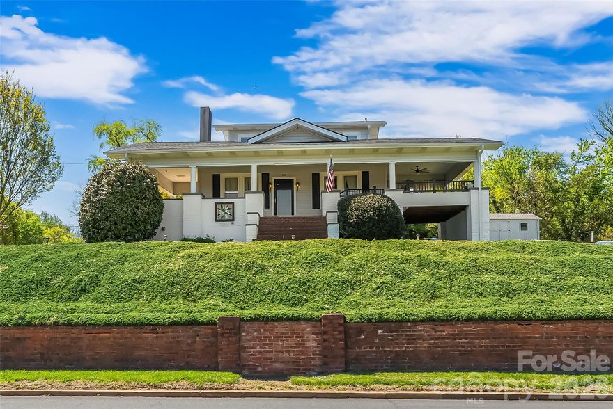 Charming home located just off historic West Union Street, offering easy access to sidewalks that lead you anywhere downtown Morganton has to offer! This inviting property features a huge wraparound porch perfect for relaxing or entertaining with a built in gas grill. Inside, you’ll find high ceilings, spacious rooms, and classic character throughout. The main level includes a primary bedroom and bath, along with a convenient laundry area. Upstairs offers two additional bedrooms filled with natural light and scenic views. The basement provides excellent space for storage, a workshop, or canning. Outside, enjoy a level backyard with endless possibilities for gardening or outdoor living, plus two outbuildings with power. Ideal for hobbies or additional storage. New roof in 2025. A well cared for home full of charm in an unbeatable location.