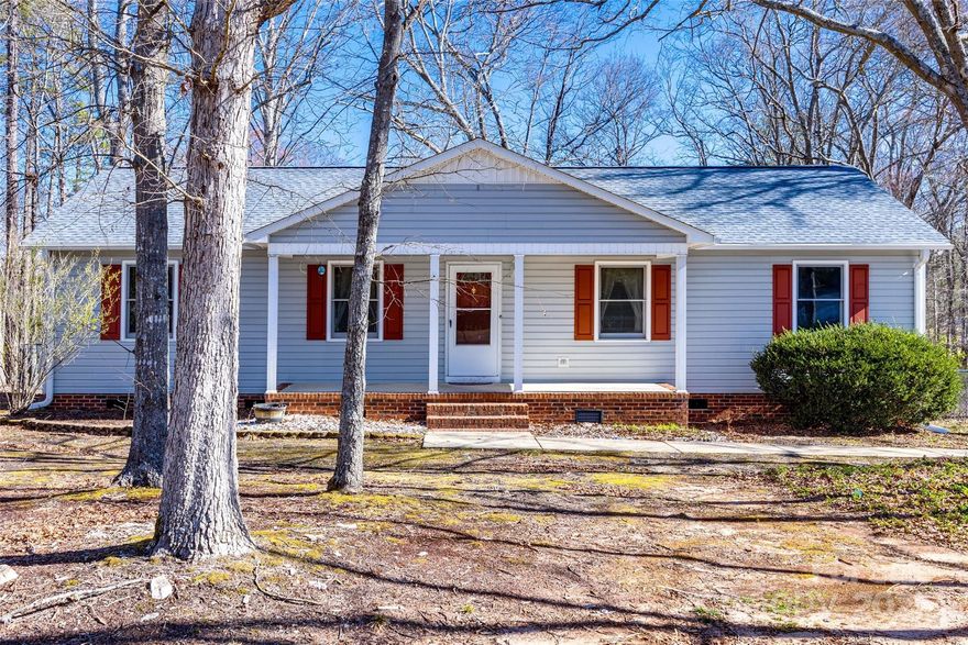 USDA eligible and NO HOA! Sellers are open to assisting with your closing costs, or rate buy-down to help reduce your mortgage payments with an acceptable offer!  Nestled on a spacious one-acre, tranquil lot near I-77, this one-story home offers a new roof (2024) with gutter guards, beautiful new laminate flooring in the living/dining rooms and both secondary bedrooms - December, 2024.  This home offers 3 spacious bedrooms/2 full baths, large open great room, kitchen has lots of cabinets and counterspace for your cooking convenience with room for your breakfast table for quick meals; the refrigerator, stove and dishwasher to remain with home.   Welcoming covered front porch greets you as you arrive, the large deck on rear overlooks the fully fenced back yard.  Large laundry room offers additional storage with built in cabinets for extra storage.  Multi car driveway.  Storage shed.  Motivated Sellers!!