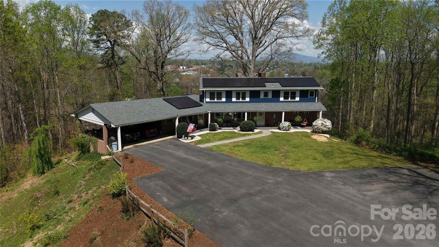 Private Mountaintop Estate | 5 Bedrooms | 11.71 Acres with Breathtaking Views of Marion
Perched high above downtown Marion on one of the highest homesites in the area, this stunning 2-story estate home offers unmatched privacy and panoramic views on 11.71 acres of pristine mountaintop land. Accessed by a picturesque paved private drive, the property borders the beautiful Mount Ida Wilderness Park — a 36-acre city preserve featuring a moderate-to-strenuous one-mile hiking trail that leads to sweeping overlooks of Short Off Mountain and downtown Marion. This rare setting delivers true privacy while placing you just minutes from town amenities. Inside, the home is designed for both elegant living and effortless enjoyment of the mountain setting. The main level features:  A fully equipped kitchen with breakfast nook; Formal dining room; Spacious great room with walls of windows offering dramatic front-to-rear views and a cozy fireplace; Luxurious primary suite with its own fireplace, private bath with jetted tub, and access to a screened covered deck. The great room opens onto a massive deck perfect for entertaining while soaking in the expansive views of Marion below. Upstairs, you’ll find four additional bedrooms and 2 full baths. One bedroom is large enough to serve as a secondary primary suite (with bathroom and walk in closet) and features its own private balcony deck. This is truly a one-of-a-kind mountain estate — combining privacy, spectacular long-range views, direct access to hiking trails, and generous living space in a peaceful, elevated setting. If you’re looking for a private mountaintop retreat with room to breathe and views that never get old, this exceptional property deserves your attention. Main Street, Marion (with all of the downtown amenities such as restaurants, the Peavine Walking Trail, the Farmers Market, etc) is approximately .3 miles away!