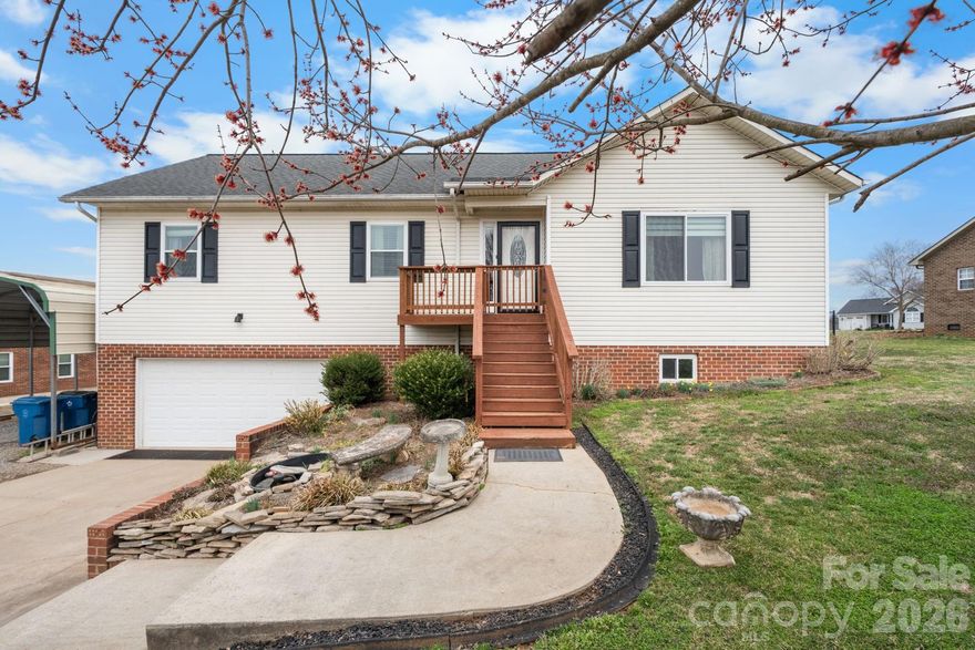 This home has all the space you've been wanting!  There are 3 bedrooms, 3 bathrooms, and 2,570 sq ft of space. The main level features a living room with a cozy fireplace, a dining room, and a spacious kitchen with stainless appliances (refrigerator included) and a pantry for extra storage. There is also a convenient laundry area off the kitchen with the washer and dryer. The primary suite has its own private bath, while two additional bedrooms share the main bath. Downstairs adds even more versatility with a den, office, flex space, and a full bath — perfect for today’s changing needs. You’ll also appreciate the oversized 572 sq ft garage with room for cars, toys, and hobbies. Plus there is a large deck overlooking the fenced backyard, and a built-in pet door so your furry companions can head out to play. With so much space and a sensible layout, this home checks the boxes. Reach out to schedule your private tour.