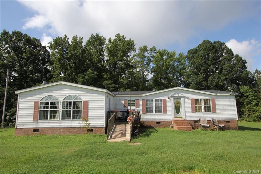 2109 SF doublewide, manufactured home on 6.01 Acres.  4 bedrooms, 2 baths.  New roof 2015. Living room, and family room, dining area.  Electric range & side by side refrigerator included.  Wood burning fireplace.