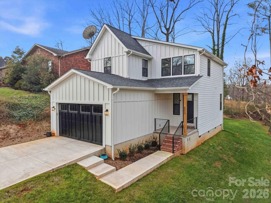 Welcome to this one-of-a-kind, nearly new home where modern design meets warm farmhouse charm. Tucked into a beautifully wooded lot, this property is surrounded by mature trees that provide privacy and natural serenity. Inside, thoughtful craftsmanship is evident throughout the 3-bedroom, 2.5-bath layout. The home features luxury vinyl flooring, plush carpeting, and modern-classic fixtures. The standout kitchen is equipped with quartz countertops and a stylish tile backsplash, opening seamlessly into the living and dining areas. The main level also includes a convenient drop-zone from the garage and a half bath. The upper level offers two generous bedrooms sharing a full bath, alongside a primary suite featuring dual sinks, a large shower, and a walk-in closet. For added convenience, the laundry room is located just off the primary suite. Seller installed a new custom Carriage House Overlay Insulated Garage Door.  A large deck and a level backyard complete this exceptional property. Every detail reflects the quality of this build, from the premium finishes to the intuitive layout. This is a home you won’t want to miss.