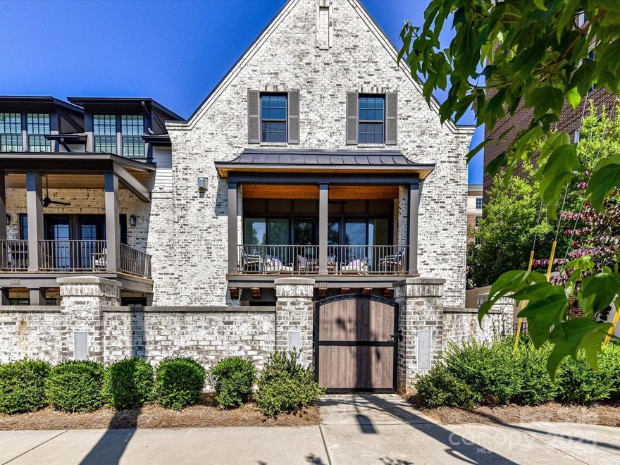 Welcome to luxury living in the heart of SouthPark! This stunning Saussy Burbank townhome, offers three levels of beautifully designed living space and is walkable to everything Southpark has to offer. A rare in-home private ELEVATOR provides convenient access to all levels. The open floorplan features hardwood flooring, a spacious living area with gas fireplace, built-ins, automated roller shades, and a chef’s kitchen equipped with Thermador appliances, gas cooktop, quartz countertops, oversized island, and premium cabinetry. Enjoy exceptional outdoor living with a private enclosed courtyard and a covered balcony. The primary boasts two walk-in closets, dual vanities, soaking tub, and heated bathroom floors. Lower level features versatile den with bedroom and ensuite offering an ideal guest setup. An epoxied 2-car garage, upgraded designer lighting, all within a charming community of just 8 townhomes. Walkable to top rated dining and shopping!