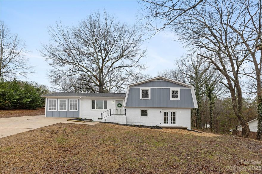 Nestled on a generous .92-acre lot, this split-level gem offers a perfect blend of expansive outdoor space and versatile living. The main floor has an inviting living area, seamlessly flowing into a well-appointed kitchen and dining space. Large windows flood the rooms with natural light, showcasing the lush outdoor surroundings. Space is plentiful in the main level bedroom with sliding doors, this can also be used a family room/den/office/playroom or whatever your heart desires. Walk down the stairs to the lower level that beckons with possibilities, presenting an ideal space for in-law accommodations. With a separate entrance, bedroom, and living area, this thoughtfully designed layout provides both privacy and connectivity.  Upstairs you'll find the primary bedroom and an additional bedroom. Your spacious retreat awaits, where every inch of the property is an invitation to create cherished memories.