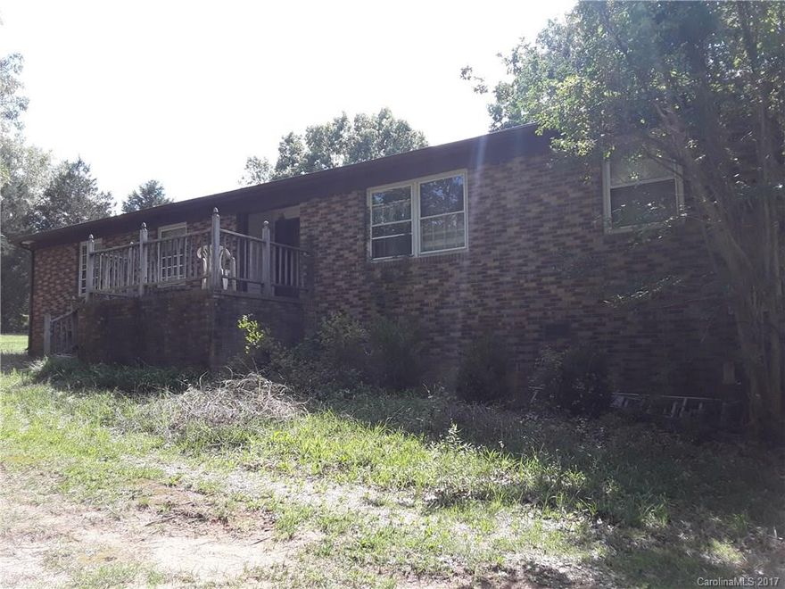Enjoy country living in this nice 3 bedroom/2 bathroom brick home with 7 acres.  No restrictions to animals or building on property.  Has a good size creek running along border.  Home needs some TLC. This is reflected in the price.  Sold as is. Come take a look today