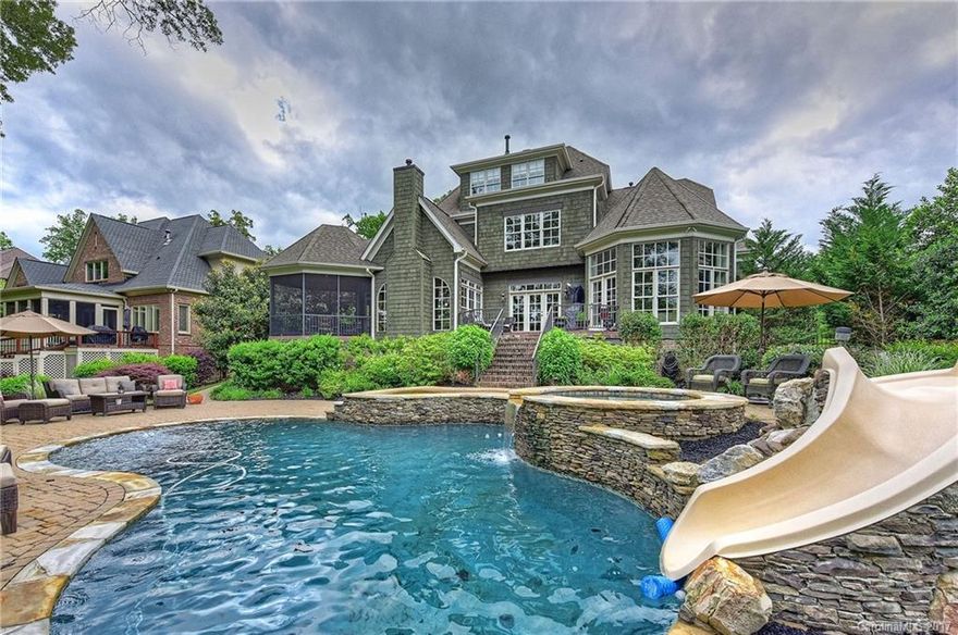 This exquisite home sits on the 3rd Tee of Springfield Golf Course! Foyer with a grand staircase, formal dining room, French doors to office. Living room with fireplace, built-ins, French doors to terrace. Kitchen with high-end appliances opens to breakfast nook and family room with vaulted ceiling, FPL, French doors to terrace. The vaulted ceiling completes the master bedroom en-suite. 4BRs/3BAs on second level. Theater on third level (could be 6thBR). Terrace & screened porch to pool/hot tub.