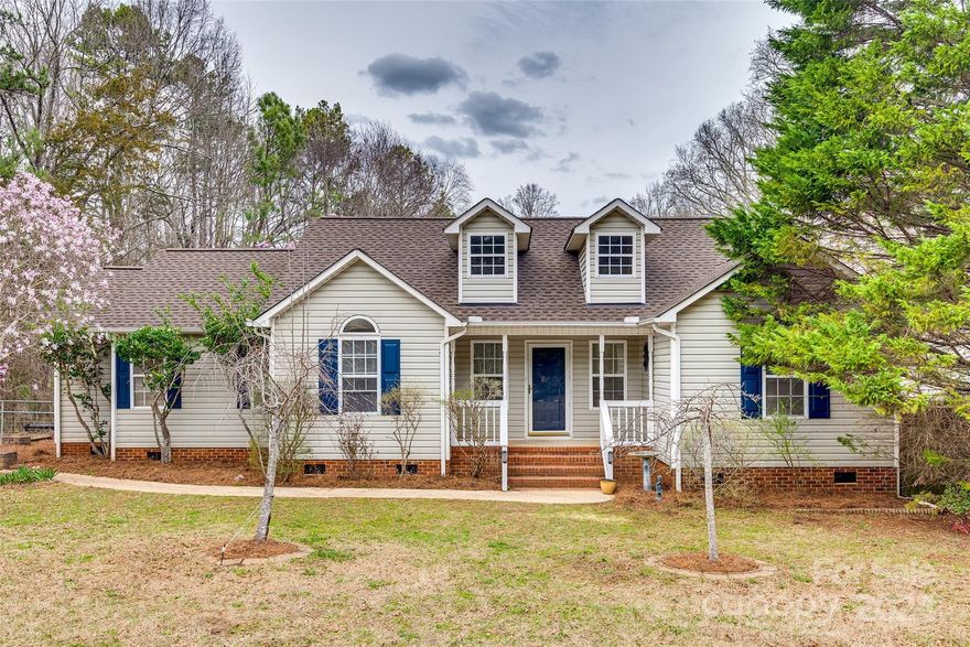 Welcome to your peaceful retreat nestled in the rural landscape of Rock Hill! Situated on an expansive flat lot spanning almost 2 acres, this property offers the perfect blend of tranquil living and modern convenience. 
Enjoy your morning coffee on the charming covered front porch or entertain on the deck in the private backyard overlooking lush trees and greenery. A detached 2-car garage offers ample space for parking and storage. Inside, discover an open floor plan, cozy fireplace in the great room and a spacious primary bedroom. Located only 10 minutes from the growing downtown Rock Hill area with a great variety of dining and retail shops. Don't miss your chance to experience the tranquility and convenience of country living while being just moments away from all that Rock Hill and the York area have to offer. Schedule a showing for your new home sweet home!