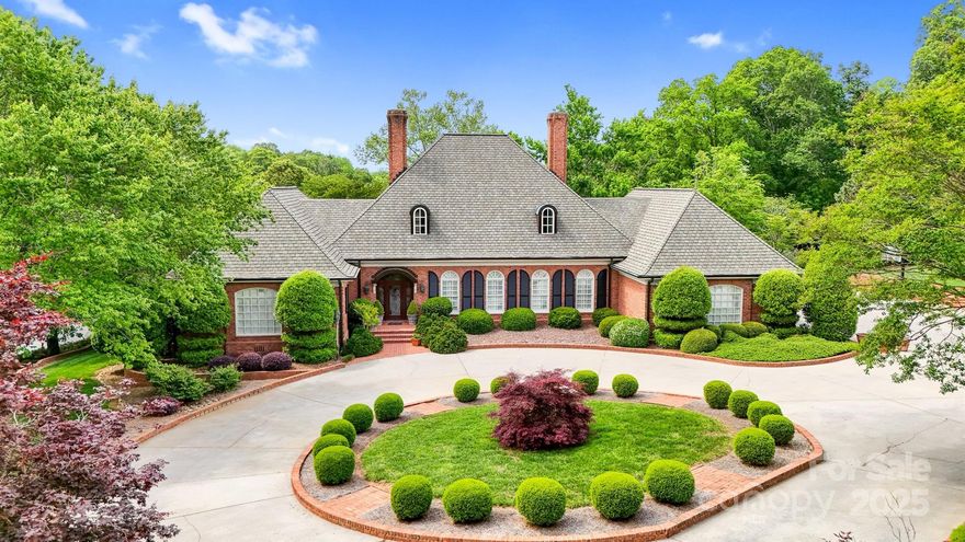 *Exquisite Lake Front Estate Offering Privacy in a Prime NW Hickory Location with No City Taxes or Restrictions*
Nestled beyond a private gated entrance on a quiet cove just off the main channel, this remarkable lakefront estate encompasses 5.63 acres of tranquility, sophistication & unmatched amenities. Designed for both relaxed living & grand entertaining, this property seamlessly blends timeless architecture with resort-style features—creating a rare opportunity in one of Hickory’s most sought-after settings. 
Step outside into your private retreat. The gunite pool—with integrated hot tub, cascading waterfall & ornate gargoyle fountains—serves as a dramatic centerpiece, complemented by gorgeous gardens and a charming brick greenhouse which extends from the pool area. Additionally, there is a cozy lake side seating area with a fire pit just steps from the pool area. A covered boat dock with two boat slips, boat lift, a jet ski slip and floating jet port ensures effortless enjoyment of Lake Hickory. A versatile barn with four stalls, tack room, loft which could be finished for another living area (1,133 sq. ft.), full bath & oversized bays, provide an ideal area for equestrian use, off-season storage of boats, jet skis or additional autos. Adjacent to the barn lies an expansive pasture bathed in sunlight. The manicured grounds are supported by lake-fed irrigation, ensuring beauty & functionality year-round.

Inside, architectural character abounds—arched brick doorways, coffered & tongue-and-groove ceilings, hickory-paneled walls & hardwood floors. Over looking the serene pool and gardens, the gourmet kitchen is a chef’s delight, featuring Thermador appliances, gas range, walk-in pantry, beverage cooler, ice maker, bar seating and   lighted display cabinetry. The built in desk/drop zone is a generous space designed for efficiency offering an organized haven where items can be arranged & safely stored. A brick archway leads into the den, where custom built-ins, a beautifully crafted wood-burning fireplace & scenic views of the pool & gardens create a warm, inviting gathering space.

The primary suite is a private sanctuary with two walk-in closets, dual spa like vanities, steam shower, soaking tub & bidet. Strategically placed between the primary suite & den, a versatile home office—once a nursery—provides a refined balance of privacy & convenience. A spacious guest suite on the main level enhances accessibility & comfort for visitors.

The formal living & dining rooms embody timeless elegance with oversized moldings & exquisite detail. The living room features a gas fireplace with vintage mantle, while the dining room is anchored by illuminated corner china cabinets & a stunning chandelier adorned with genuine Strass crystals.

Upstairs, two large bedrooms share a Jack & Jill bath, each with walk-in closets. Storage is abundant, highlighted by a 344 sq. ft. walk-in storage room accessed through one of the walk-ins (formerly served as a sewing room), dormer-to-dormer floored storage & a hall closet with custom shelving for linens & tableware. The expansive billiard room, accessed by both the formal winding staircase & a back stairwell from the kitchen, connects to a massive bonus room with tongue-and-groove ceiling & walk-in closet—perfect as a media room, gym, office or playroom.

The well appointed laundry room includes a washer & dryer with a spacious folding counter above, custom cabinetry, utility sink & a full-size stand-up freezer surrounded by abundant storage & additional counter top  space.

An oversized 4 car garage with workbench & storage area adds practicality to the property, blending seamlessly with its luxury design.

From sunlit mornings in the greenhouse to tranquil evenings by the fire pit, this estate captures the essence of comfort, privacy & prestige. With its premier location, exceptional craftsmanship & unparalleled amenities, it is truly a once-in-a-lifetime offering on Lake Hickory.