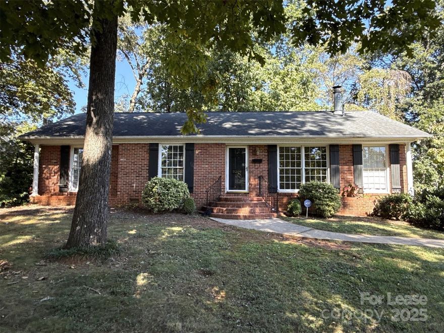 Lovely brick ranch in the heart of Charlotte. The kitchen is complete with stainless steel appliances, beautiful wood cabinets, tiled backsplash, and a dining nook. The spacious living room has hardwood flooring and a wood-burning fireplace. Natural light is always in abundance with lots of windows around the home. One primary bedroom and 2 other bedrooms are all carpeted. Enjoy the beautiful fall weather in the backyard. Please note, renters insurance is required.
